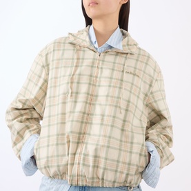 Model wearing Acne green and orange check cotton jacket with zip fastening, styled with a light blue shirt