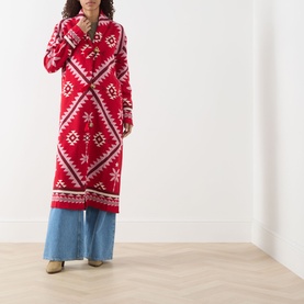 Model wearing Hayley Menzies Sundance Printed Duster Cardigan in red with geometric tapestry motifs, shawl collar, styled with wide-leg jeans