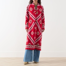 Model wearing Hayley Menzies Sundance Printed Duster Cardigan in red with geometric tapestry motifs, shawl collar, styled with wide-leg jeans.