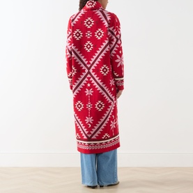 Model wearing Hayley Menzies Sundance Printed Duster Cardigan in red with tapestry motifs, styled with light blue jeans. Back view.
