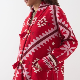 Model wearing Hayley Menzies Sundance Printed Duster Cardigan in red with geometric tapestry motifs, shawl collar, and fringe trim detail