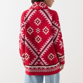 Model wearing Hayley Menzies Sundance Printed Cardigan in red with geometric tapestry motifs, shawl collar, back view shown.