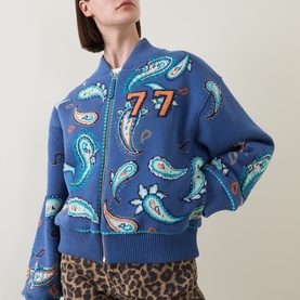 Model wearing Hayley Menzies Jimi Bandana Print Bomber Jacket in blue with paisley print and zip front, styled with leopard print trousers.