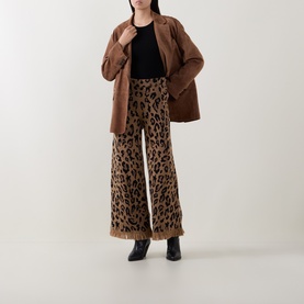 Model wearing Hayley Menzies Cosmic Cat wide-leg trousers with brown oversized blazer and black ankle boots.