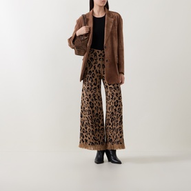 Model wearing Hayley Menzies Cosmic Cat trousers in leopard print with frayed hem, styled with a brown blazer and black ankle boots