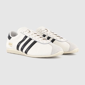 Adidas trainers in core white and core black, three-stripe detail, suede toe cap, cream midsole, gold branding accent