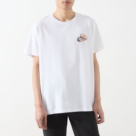 Model wearing Levis You've Been Served Graphic T-Shirt in white, crew neck, short sleeves, small chest graphic, styled with black trousers