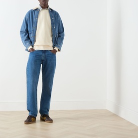 Model wearing Levis Garment Dye Rutabaga sweatshirt, styled with blue denim jacket, mid-blue jeans and brown trainers.