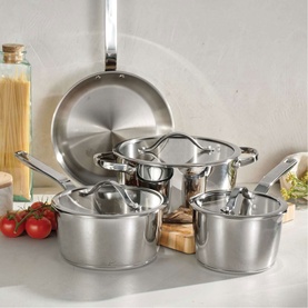 Tramontina silver stainless steel cookware set including frying pan, lidded saucepans, and stockpot, styled on a kitchen counter