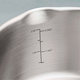 Tramontina silver stainless steel saucepan interior with etched measurement markings showing 1.0L to 2.0QT capacity scale