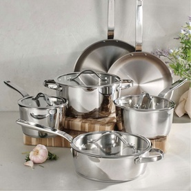 Tramontina silver stainless steel cookware set with glass lids, including saucepans, stockpot and frying pan, styled on wooden board