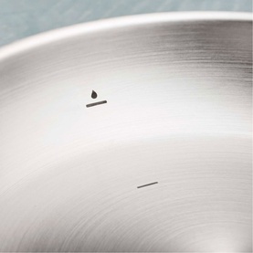 Tramontina silver stainless steel cookware, close-up showing brushed metallic surface with water-resistance symbol detail