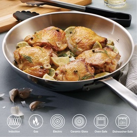 Tramontina silver stainless steel frying pan with cooked chicken and vegetables, showing induction, gas, ceramic-glass, oven-safe and dishwasher-safe