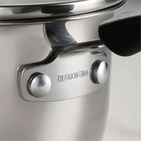 Tramontina silver stainless steel cookware close-up showing engraved brand logo, riveted black handle attachment and polished finish.