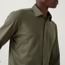 Model wearing Rodd & Gunn Ascot Park Shirt in khaki, showing pointed collar, button fastening and long sleeves in cotton fabric.