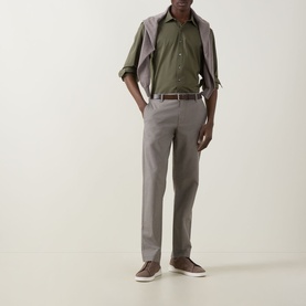 Model wearing Rodd & Gunn Ascot Park Shirt in khaki with grey trousers, brown belt, and suede trainers