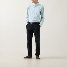 Model wearing Rodd & Gunn Cambridge Oxford Shirt in Fern, styled with dark navy trousers and brown belt.