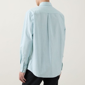 Model wearing Rodd & Gunn Cambridge Oxford Shirt in Fern. Back view showing rear box pleat, long sleeves, and buttoned cuffs.