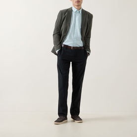 Model wearing Rodd & Gunn Cambridge Oxford Shirt in Fern with dark navy trousers, olive blazer, and tan loafers.
