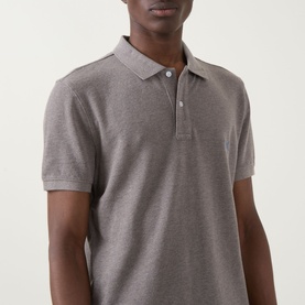 Model wearing Rodd & Gunn The Gunn Polo Shirt in Mocha, showing flat collar, short sleeves and button fastening at neckline