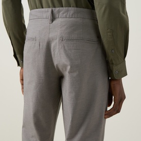 Model wearing Rodd & Gunn Gunn Straight Leg Chinos in Latte, rear view showing jet pockets and belt loops, styled with olive shirt