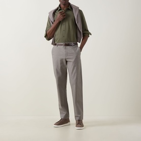 Model wearing Rodd & Gunn Gunn Straight Leg Chinos in Latte with olive shirt and grey jacket, styled with brown suede trainers