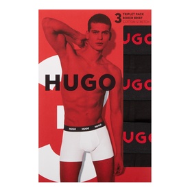 Hugo Three-Pack Solid Logo Boxer Briefs in black, shown in retail packaging with model wearing one pair, white logo waistband visible.