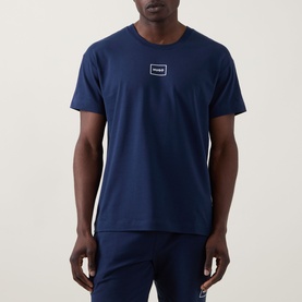 Model wearing Hugo Laze Logo Lounge T-Shirt in navy, crew neck with logo badge, styled with matching navy lounge trousers