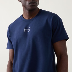 Model wearing Hugo Laze Logo Lounge T-Shirt in navy, featuring crew neck and small logo badge on chest