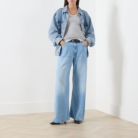Model wearing Mother Wide Leg jeans in blue, styled with a denim jacket and striped tee. Relaxed fit with a clean, faded wash.