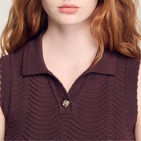 Model wearing Sandro Wave Cropped Knit Top in brown, sleeveless with buttoned polo collar and wave-texture knit detail