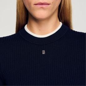 Model wearing Sandro Layered Effect Ribbed Sweater in navy blue with contrasting white collar detail and signature logo tag.
