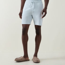 Model wearing Hugo Boss Logo Waffle Texture Drawstring Lounge Shorts in light blue, styled with taupe suede loafers.