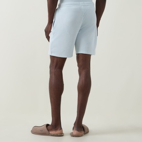 Model wearing Hugo Boss Logo Waffle Texture Drawstring Lounge Shorts in light blue, rear view, styled with taupe slides.