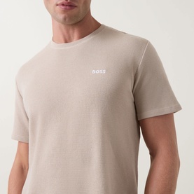 Model wearing Hugo Boss Waffle Texture Lounge T-Shirt in Light Beige with crew neck, short sleeves, and white contrast chest logo.