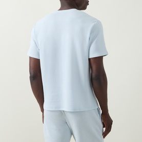 Model wearing Hugo Boss Logo Waffle Texture Lounge T-Shirt in light blue, back view, paired with matching light blue lounge trousers.