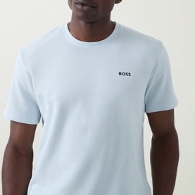 Model wearing Hugo Boss Logo Waffle Texture Lounge T-Shirt in light blue with round neck and embroidered chest logo.