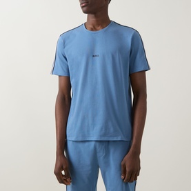 Model wearing Hugo Boss light blue cotton pyjama top with contrast stripe shoulders and small chest logo, styled with matching blue trousers