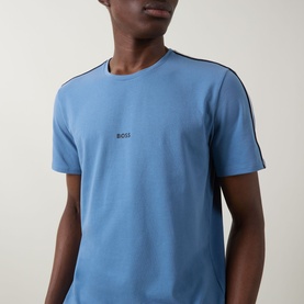 Model wearing Hugo Boss light blue cotton pyjama top with contrast shoulder stripe trim and embroidered logo at chest.