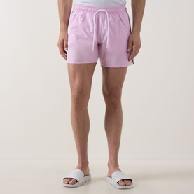 Model wearing Hugo Boss Iconic Logo Swim Shorts in bright pink with elasticated drawstring waist, styled with white slider sandals