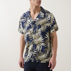 Model wearing Hugo Boss dark beige tropical leaf print short-sleeve camp collar shirt in 100% viscose