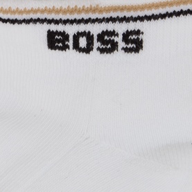 Hugo Boss Iconic Stripe Ankle Socks Three-Pack in white, close-up showing black BOSS logo and gold stripe ribbed cuff detail.