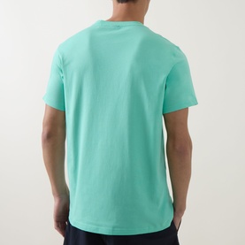 Model wearing Hugo Boss bright green cotton T-shirt, rear view showing crew neck and short sleeves.