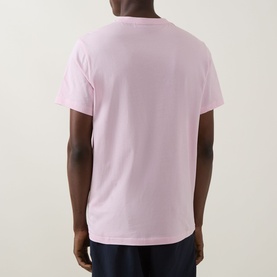 Model wearing Hugo Boss Big Logo T-Shirt in Bright Pink, rear view, crew neck, short sleeves, straight hem, paired with navy trousers