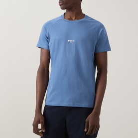 Model wearing Hugo Boss light blue t-shirt with small centre chest logo, paired with navy shorts.