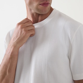 Model wearing Hugo Boss Structure Logo Textured Lounge T-Shirt in Natural, showing ribbed texture detail at chest and round neckline.
