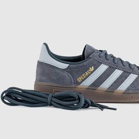 Adidas Spezial trainer in Aurora Onix and Halo Silver suede, three white stripes, gold logo, gum sole, with laces extended in foreground