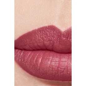 CHANEL Rouge Allure Velvet Luminous Matte Lip Colour worn on lips, shown in a deep rosy mauve matte finish close-up