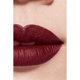 CHANEL Rouge Allure Velvet Luminous Matte Lip Colour worn on lips in a deep matte burgundy-red shade, close-up lip shot