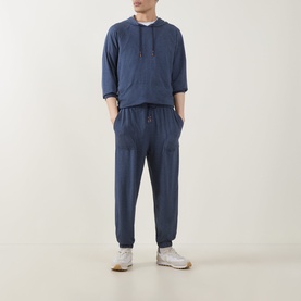 Model wearing Paul Smith Access Harry Lounge Sweatpants in blue, slim-leg with cuffed ankles and drawstring waist, styled with matching blue hoodie.